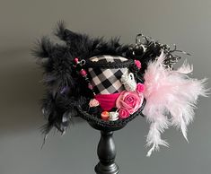 DreamsHead presents its novelty Gorgeous mini pink and black tea hat Covered with a pink polka dot fabric on the underside and a black and white checkered fabric, a bright pink satin ribbon and a black braid It is decorated with a mini porcelain cup and a mini cupcake It will elegantly adorn your head and enhance your outfit. An avalanche of feathers comes to finish the hat Dimensions: 8.90cm high and 11.50cm wide at the edge All of my items are completely handmade by me Item color may differ fr Cat Tea Party, Alice In Wonderland Hat, Tea Hat, Hat Tea Party, Tea Hats, Mad Hatter Hat, Blue Velvet Fabric, Chat Halloween, Steampunk Hat