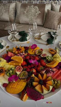 a large plate filled with fruit on top of a table