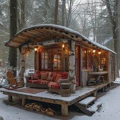 a small cabin in the woods with snow on the ground