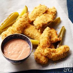 fried pickles and dipping sauce on a paper towel next to some pickle wedges