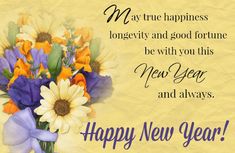 a vase filled with flowers sitting on top of a yellow table next to a happy new year message