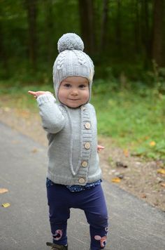 "This cute kids beanie is perfect accessory for any children outfit for all occasions. Your child is ready to look cute in this delightful, soft and comfortable hand knitted gray beanie with ear flaps decorated with cables throughout the hat. The hat is made of 100% merino wool for a stretchy and comfortable fit. Merino wool is breathable and active fiber that reacts to changes in body temperature and discourages sweating. Sizes of this beanie are according the circumference of the head or age. Winter Hats For Playtime, Cute Warm Bonnet For Winter, Warm Cute Bonnet For Winter, Cute Warm Winter Bonnet, Winter Playful Soft Knit Bonnet, Cute Warm Beanie In Acrylic Yarn, Cute Adjustable Crochet Hat For Winter, Cute Adjustable Crochet Winter Hat, Cute Hand Knitted Winter Bonnet