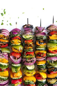 an array of grilled vegetables arranged on skewers