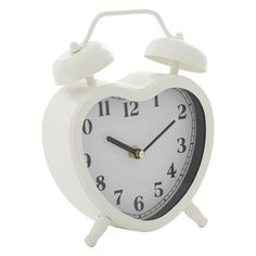 a white alarm clock with black hands and numbers on the face is shown in front of a white background