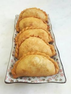 several pastries are lined up on a plate