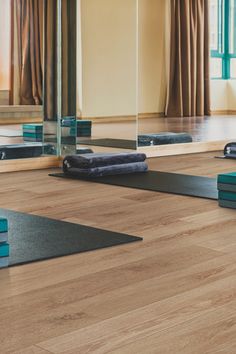 yoga mats on the floor in front of a mirror