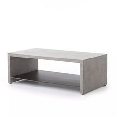 a concrete coffee table with two shelves on each side