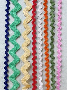 multicolored crochet ribbon on white background with clippings in different colors