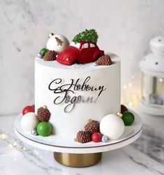 a white cake with christmas decorations on top