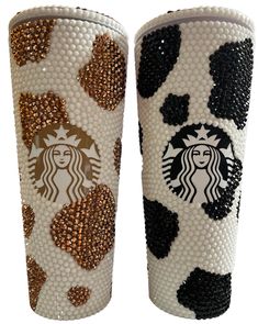 two starbucks cups decorated with gold and black hearts