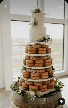 a wedding cake with donuts stacked on top