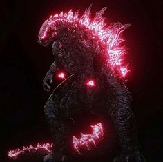 godzilla in the dark with red lights on its face and tail, looking like it has glowing eyes