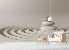 a white chair sitting in front of a wall with rocks on it and a lamp hanging from the ceiling