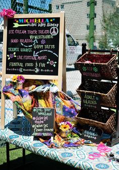 a table topped with lots of food and baskets next to a sign that says ice cream truck treats