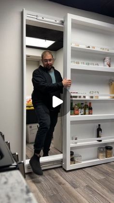 a man is standing in an open refrigerator