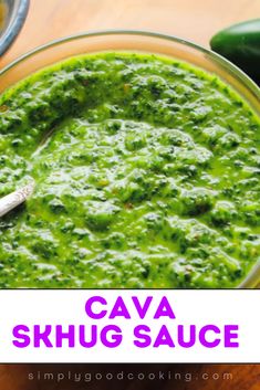 a bowl full of green sauce with a spoon in it and the words cava skhug sauce above it