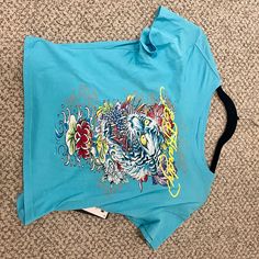 Brand New Urban Decay Ed Hardy Crop Top From July 2023. Originally $45.00. Significant Discount And Great Quality. Blue Y2k Short Sleeve Top, Blue Y2k Style Short Sleeve Top, Y2k Blue Short Sleeve Top, Y2k Short Sleeve Blue Top, Y2k Style Blue Short Sleeve Tops, Blue Y2k Top With Graphic Print, Blue Y2k Crop Top, Summer Blue Crop Top With Graphic Print, Blue Graphic Print Crop Top For Summer