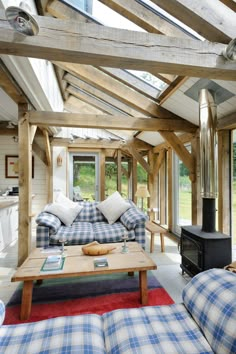 a living room filled with furniture and a fire place in the middle of an open floor plan