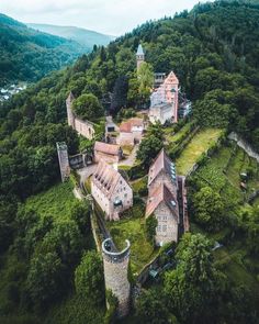 an aerial view of a castle surrounded by trees