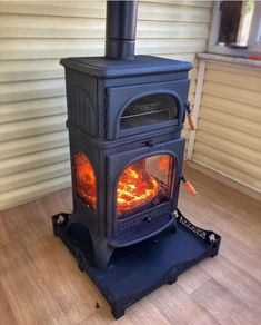 a wood stove sitting on top of a hard wood floor