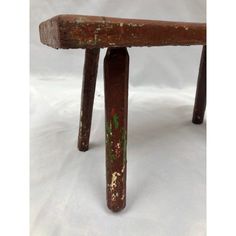 an old wooden bench with rusted paint on it