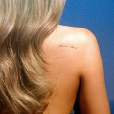 the back of a woman's head with a tattoo on her left shoulder that says you can