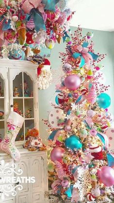 a christmas tree decorated with pink, blue and white ornaments