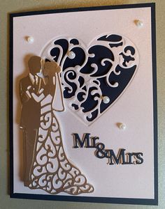 a wedding card with a bride and groom holding each other's hand in the shape of a heart