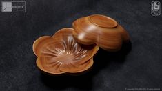 two wooden bowls sitting next to each other