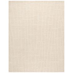 an area rug with white linen on the floor and beige carpet in the background,