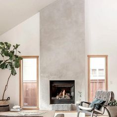 a living room filled with furniture and a fire place next to a wall mounted fireplace