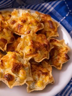 a white plate topped with cheesy bread on top of a blue and white table cloth