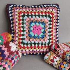 a crocheted pillow and blanket are on display