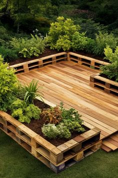 a wooden deck surrounded by lots of green plants and trees in the middle of it