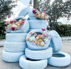 a stack of tires with flowers on them