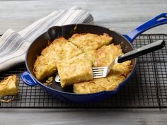 a pan filled with food sitting on top of a metal rack next to a fork