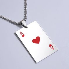 a playing card necklace with two hearts on it