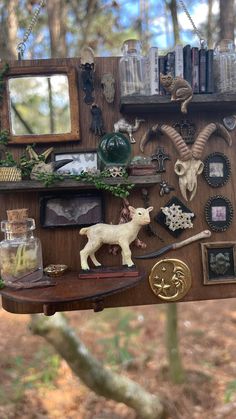 a wooden shelf filled with lots of assorted items and animals on top of it