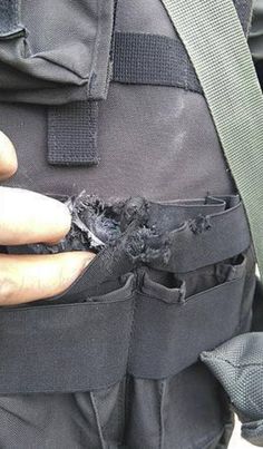 a person holding something in their pocket with it's contents ripped off the back