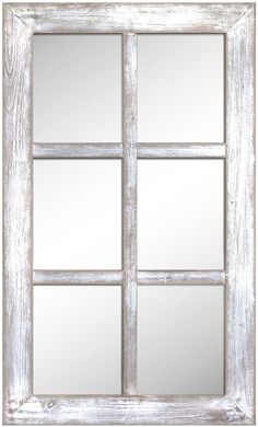 an old white window frame with four panes and mirrors on the front, one is empty