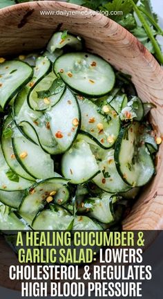 cucumber and garlic salad in a wooden bowl with text overlay that reads, a healing cucumber & garlic salad - lowers choles