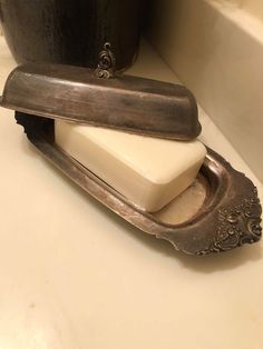 a soap dispenser sitting on top of a bathroom counter next to a tub