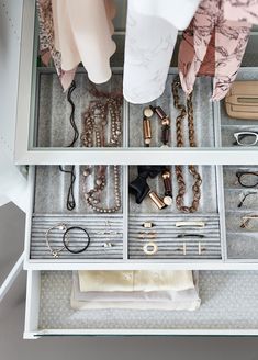 an organized drawer with clothes and jewelry