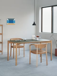 a table and chairs in a white room