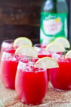 two wine glasses filled with red liquid on a yellow tray