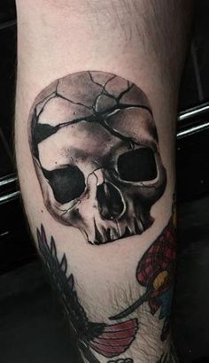 a man with a skull tattoo on his leg