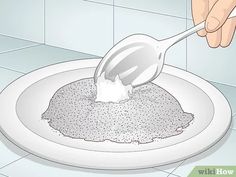 a spoon is being used to mix something in a bowl on a plate with tile walls