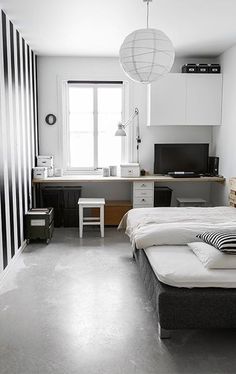 a bedroom with black and white striped walls