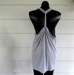 a mannequin wearing a gray top with a cross back