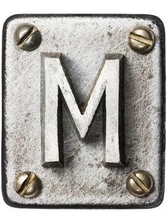 the letter m is made out of metal and has screws on it's sides